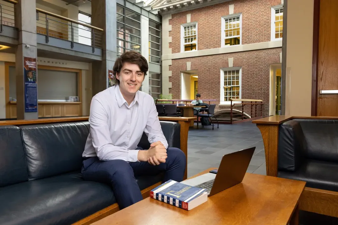 Student David Bruen sitting and smiling.